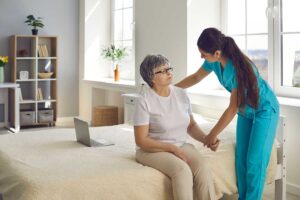 Older adults sharing a quiet conversation at a table in a bright assisted living common room.